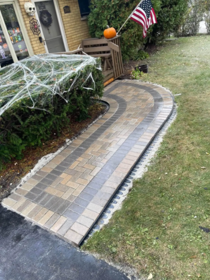 Curved multi-tone paver walkway leading to a front entry